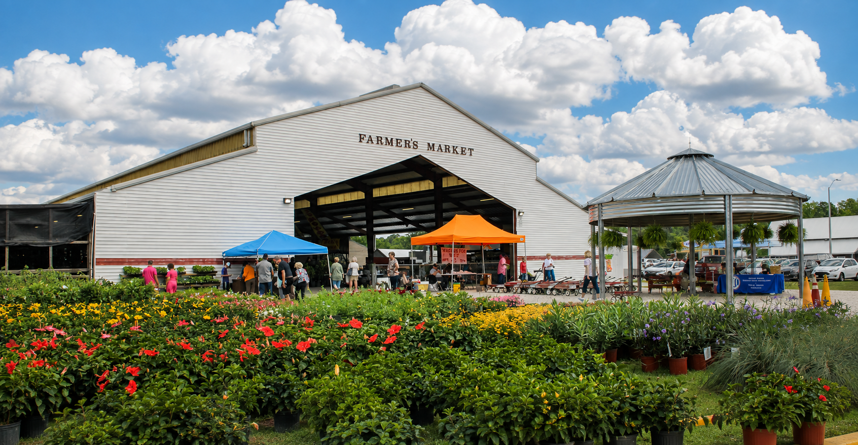 Binzebo beside a farmers market pavilion surrounded by flowers
